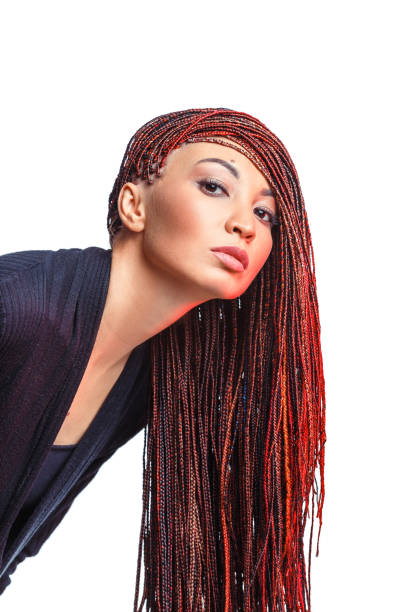 Isolated on white woman with colorful hair braided in thin plaits or dreadlocks in african style Isolated on white woman with colorful hair braided in thin plaits or dreadlocks in african style black woman hair extensions stock pictures, royalty-free photos & images