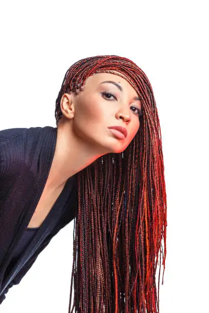 Photo of Isolated on white woman with colorful hair braided in thin plaits or dreadlocks in african style