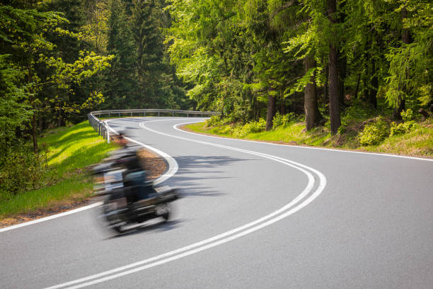 istock motorcyclist riding on the mountain road 1158695087