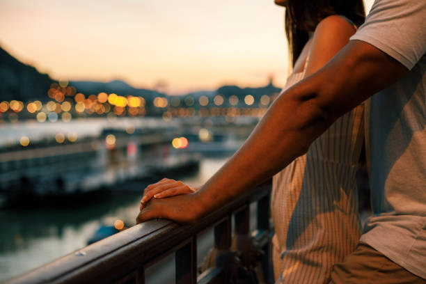 istock Close-up of couple's hands on fence while exploring the city 1158695236