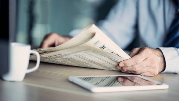 istock Businessman reading the newspaper on table 1158701274