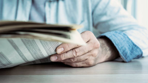 istock Businessman reading the newspaper on table 1158701276