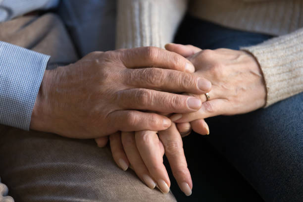 istock Close up image of elderly couple holding hands 1158702064