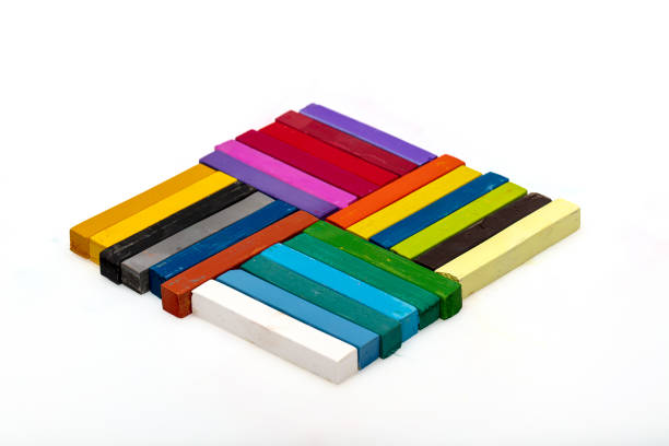 Colored chalks. Square colorful pastel chalks tops closeup, on white background.Education concept.