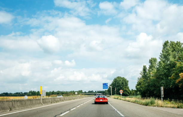 France - Aug 15, 2018: Driver point of view pov at the front driving red  sporty classical Corvette car on French highway