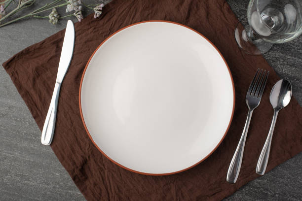 istock Empty plate in the form of a mockup, Flatlay, against a dark background, concept romance, dinner, food 1158710238