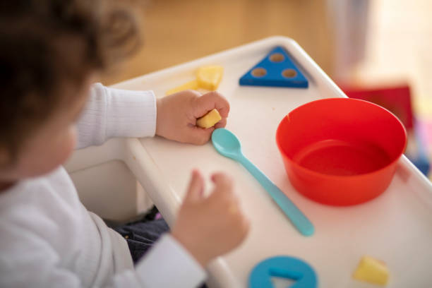 istock Baby boy eating on his own 1158712011