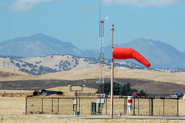 Weather station at small airport including wind sock, anemometer, and wind vane.