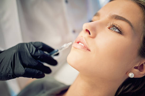 giovane donna sulla procedura di trattamento della bellezza - attractive female human collagen syringe injecting foto e immagini stock