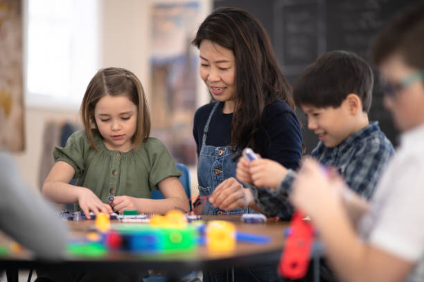 istock Asian Teacher Helping her Students 1158716661