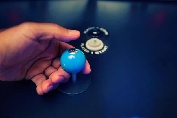 istock Hands of a video gamer holding a classic 4 way joystick with custom top fire modification and arcade buttons. 1158716762