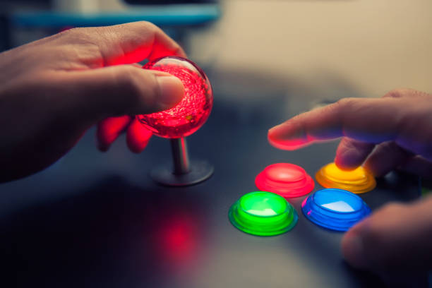 Arcade game machine with huge 45mm red ball top joystick and lighted four button layout. stock photo
