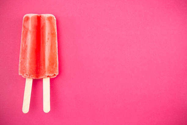 istock Red Popsicle on a Bright Pink Background 1158717760
