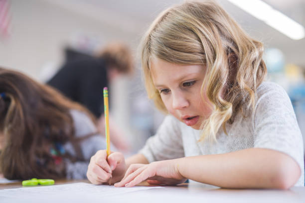istock First grade girl working in the classroom 1158717805