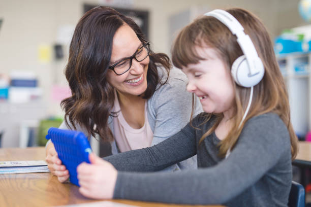 istock Teacher helping a first grader in her classroom 1158717817
