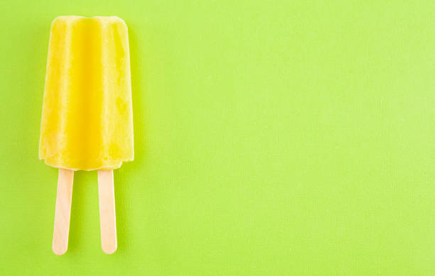 istock Yellow Popsicle on a Bright Green Background 1158717831