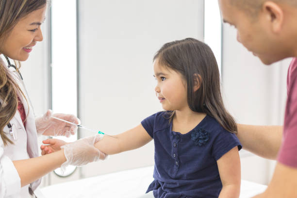 istock Young ethnic girl at the doctor's office getting a shot 1158717857