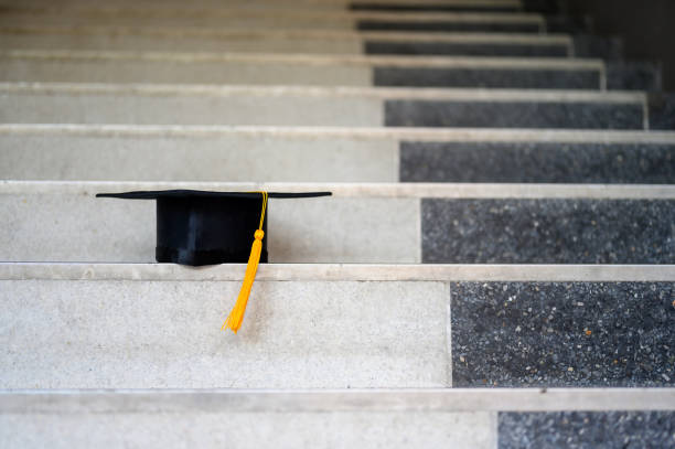 istock Black Graduation Hat placed on the steps of the corridor 1158718089