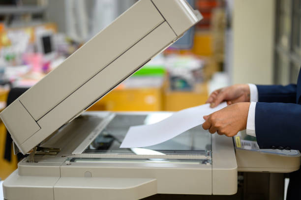 istock Employees are copying documents with a copy machine at the office. 1158718099