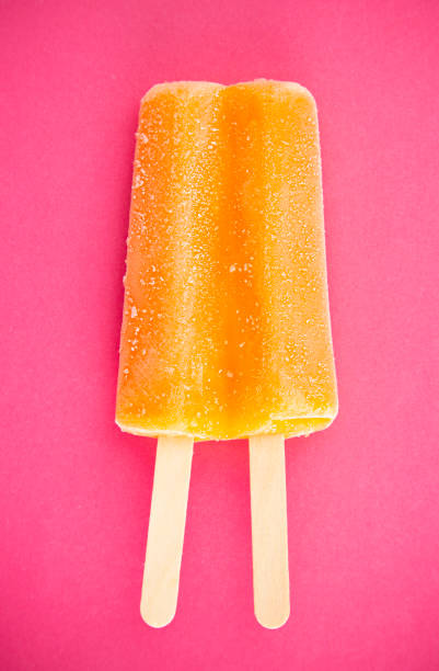 istock Orange Popsicle on a Bright Pink Background 1158718617