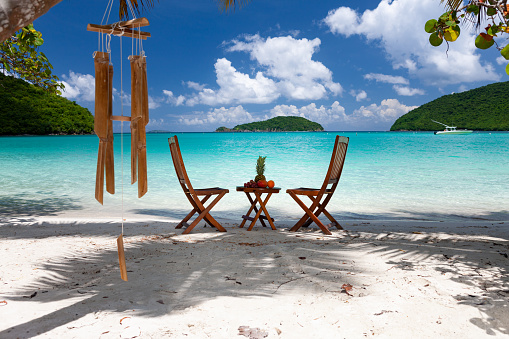 inviting chairs and fruit bowl on a tropical beach, maho bay beach, St. John, Virgin Islands