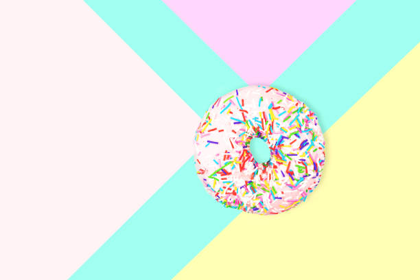 istock A pink doughnut with colorful sprinkles isolated on white. 1158722692