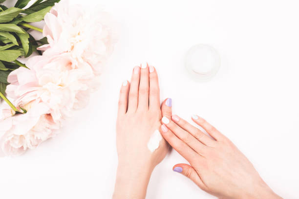A jar with a cream in woman hands.