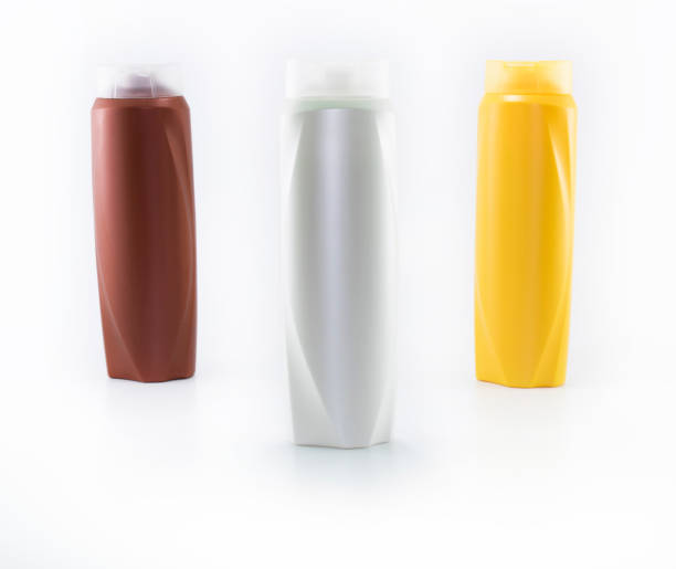 istock Shampoo, moisturizing bottles in brown, white, yellow colors. Shooting in white background. 1158723466
