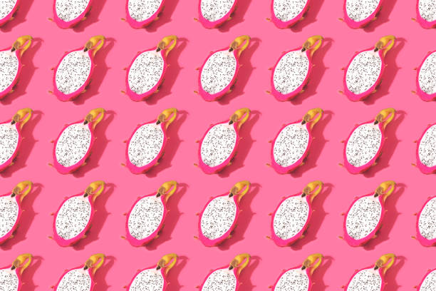 istock Seamless tropical pattern made with dragon fruit on pink background. 1158723485