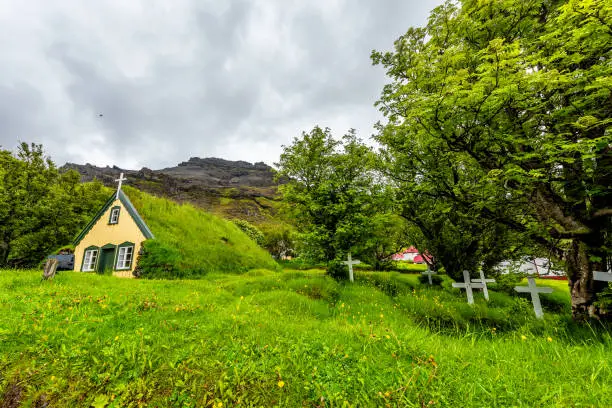 Photo of Hof, Iceland church that was the last build in traditional turf style, Hofskirkja, building roof covered in green grass