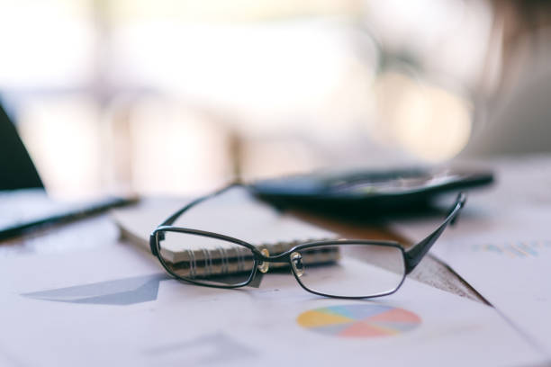 istock black eyeglasses with paperwork on the table 1158728971