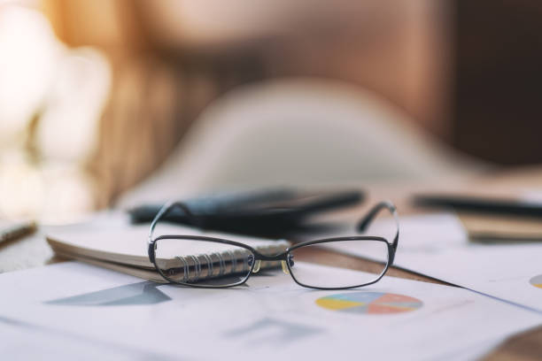 istock black eyeglasses with paperwork on the table 1158728973
