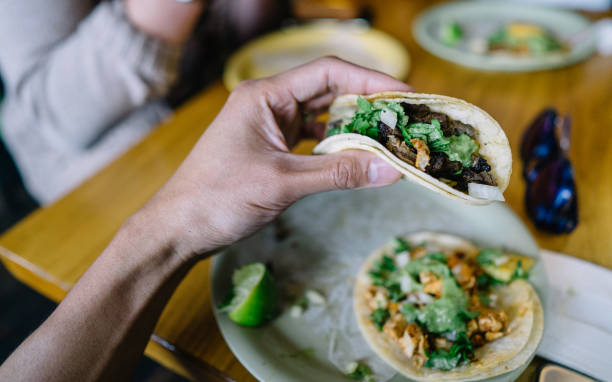 istock Person holding pork taco ready to be eaten 1158733255
