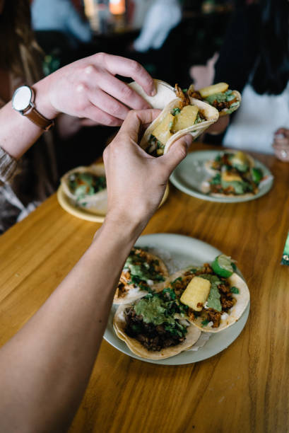 istock Group of people toasting their tacos 1158733257