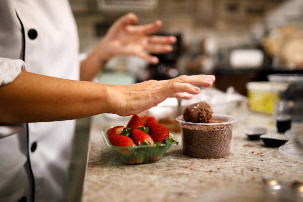 Woman patissier preparing sweets.