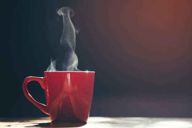istock Red cup of coffee  on black background 1158738230