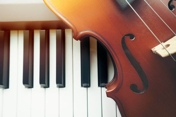 istock Violin on piano keyboard ,top view 1158738256