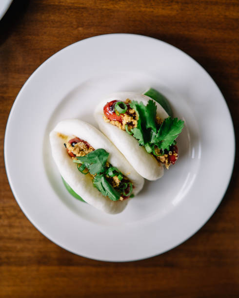 ein teller bao mit hotdogs als protein - baozi stock-fotos und bilder