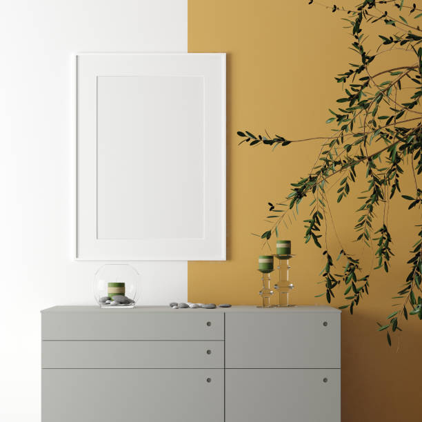 istock Poster frame mockup with decor on table and plant on empty white wall background 1158739460