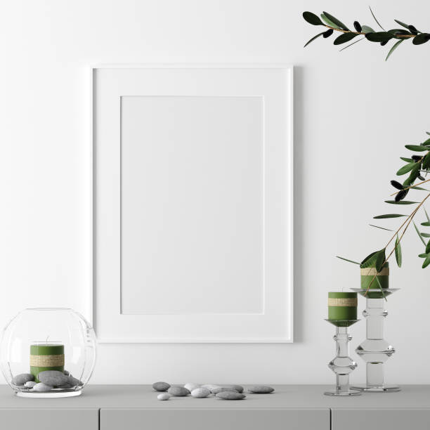istock Poster frame mockup with decor on table and plant on empty white wall background 1158739461