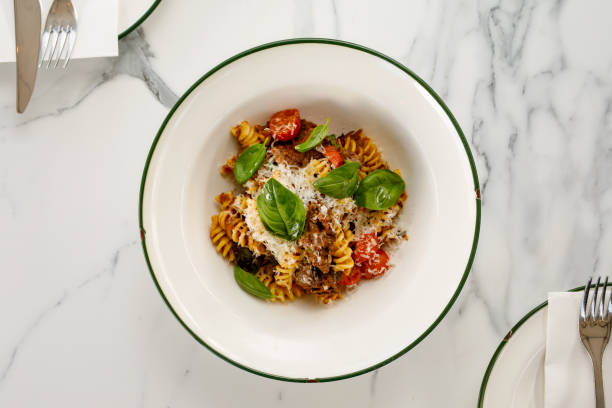 Fusilli Pasta with beef cheek ragu, onion, tomato, and basil