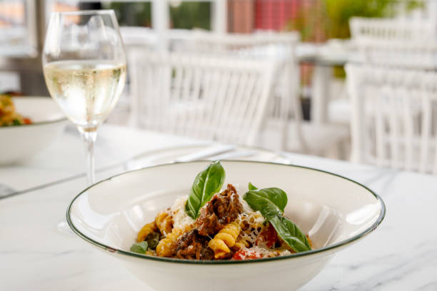 Fusilli Pasta with beef cheek ragu, onion, tomato, and basil