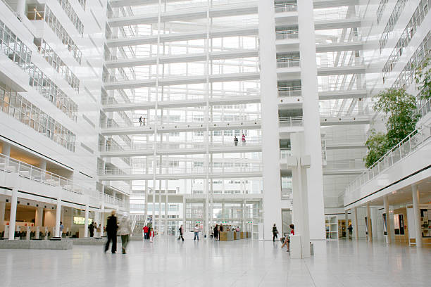 Public space Inside a huge white public building. wide stock pictures, royalty-free photos & images