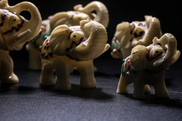 istock Herd of white-patterned elephants. Side shot. Black Background 1158746510