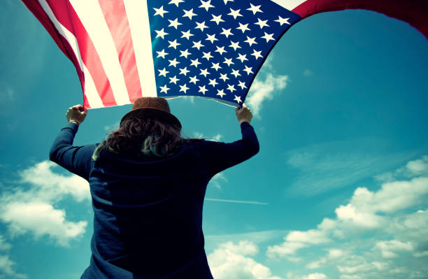 istock Woman with USA flag. 1158746589