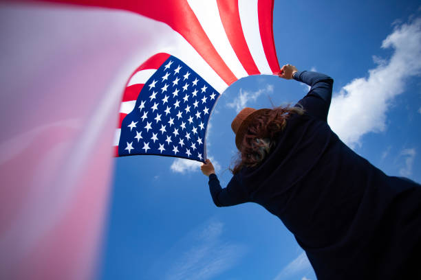 istock Woman with USA flag. 1158747104