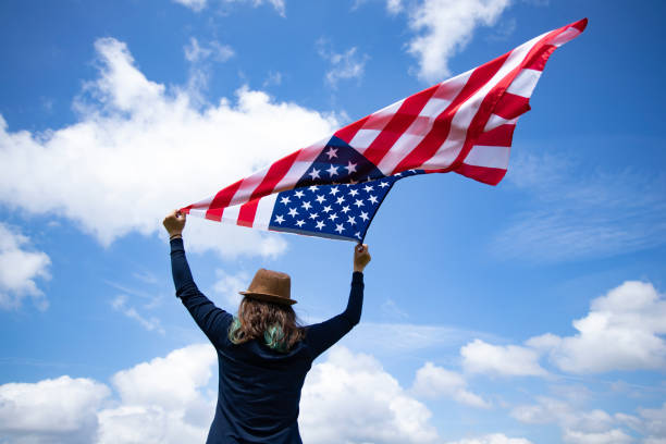 istock Woman with USA flag. 1158747141