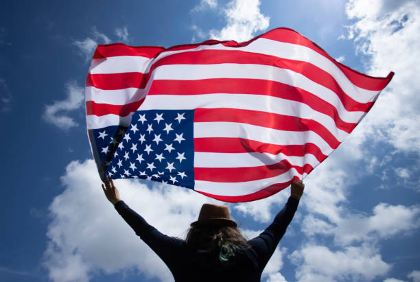 istock Woman with USA flag. 1158747205