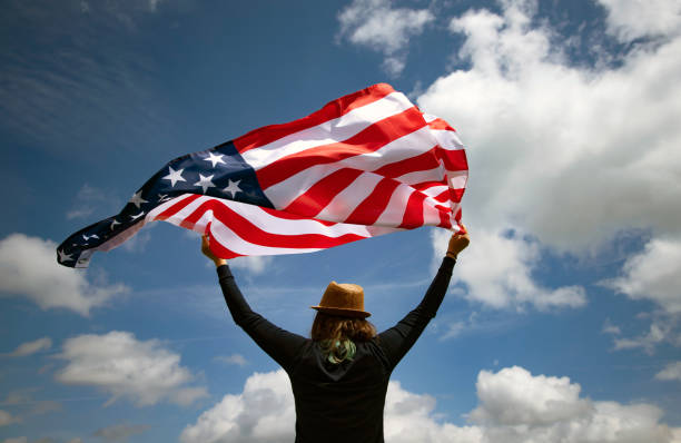 istock Woman with USA flag. 1158747213