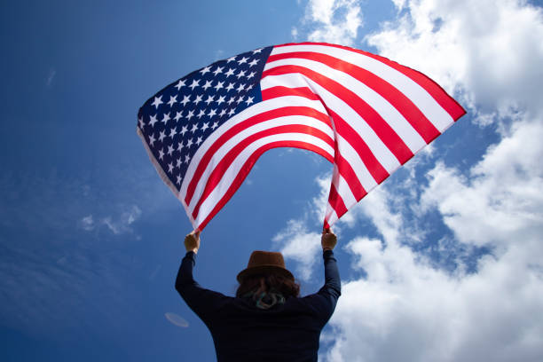 istock Woman with USA flag. 1158747279